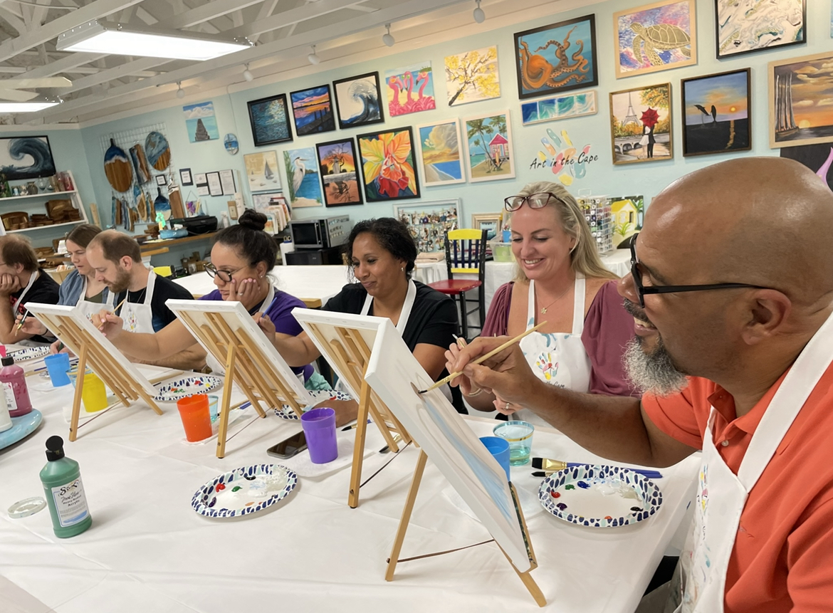 smiling group of people painting